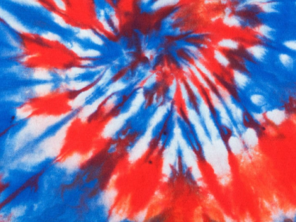 A vibrant red, white, and blue tie-dye pattern with swirling shapes and a starburst effect.