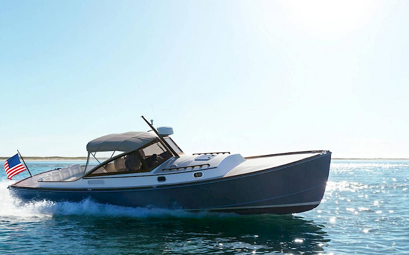 A boat cruising on water under a clear sky with an American flag at the rear.