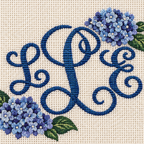 The image shows an embroidery design with the initials "L P E" in blue thread, surrounded by blue and purple flowers with green leaves.