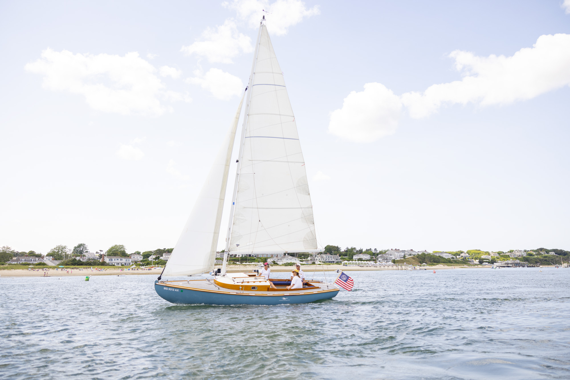A sailboat on calm waters during a serene sunset, with gentle waves and a peaceful horizon.