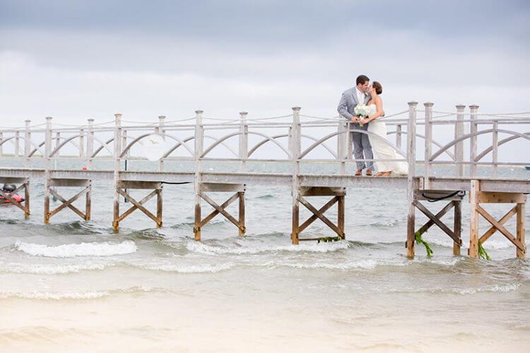 Couple kissing on a pier