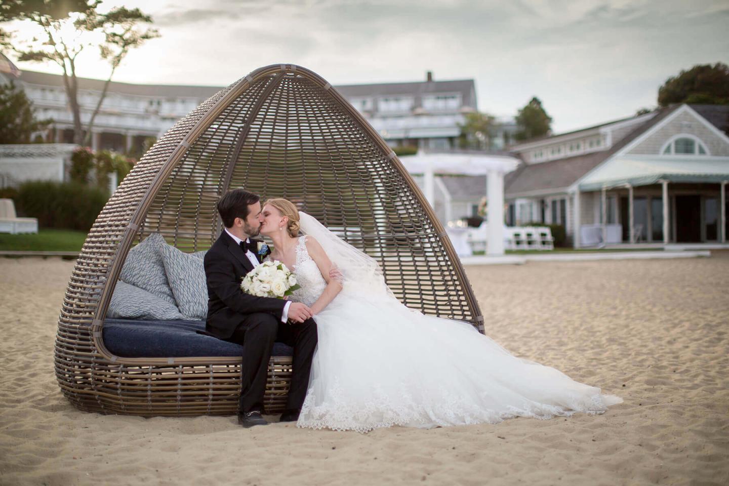 Bride and groom kiss on the beach