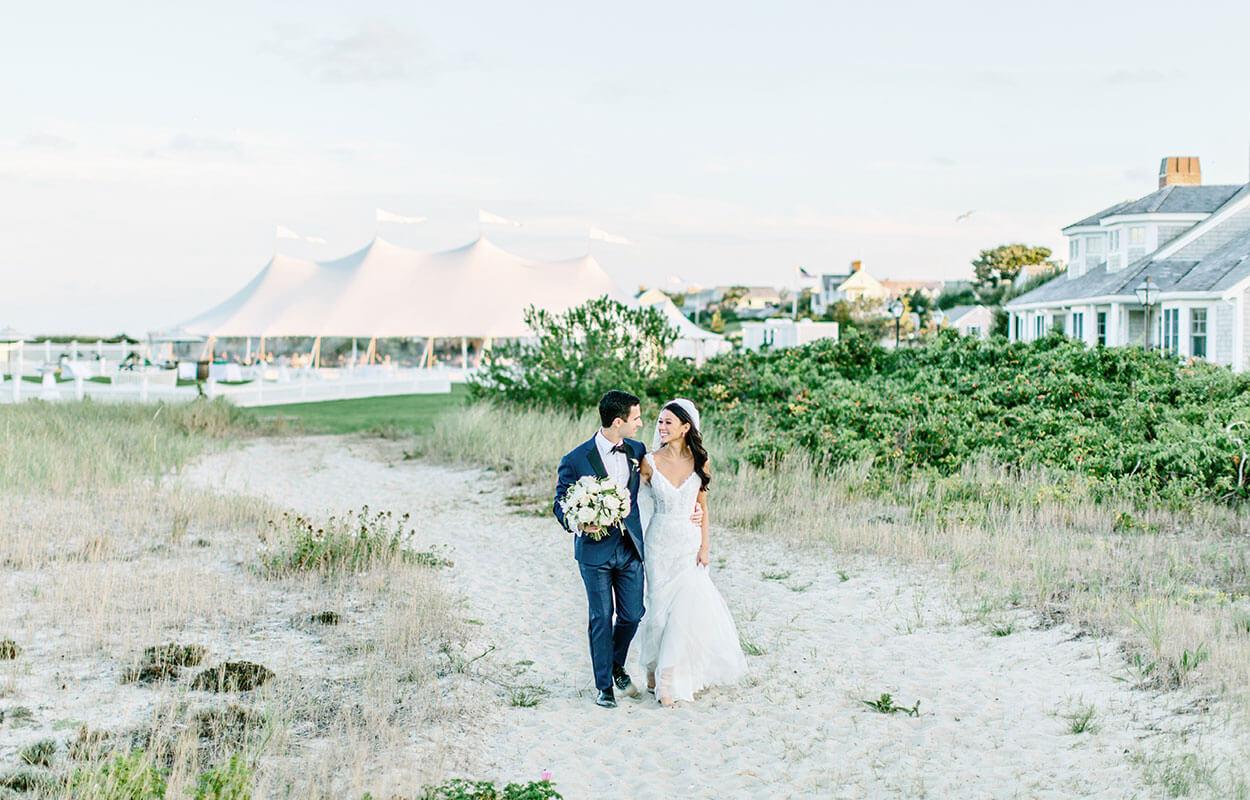 Newly wed couple walking on the beach