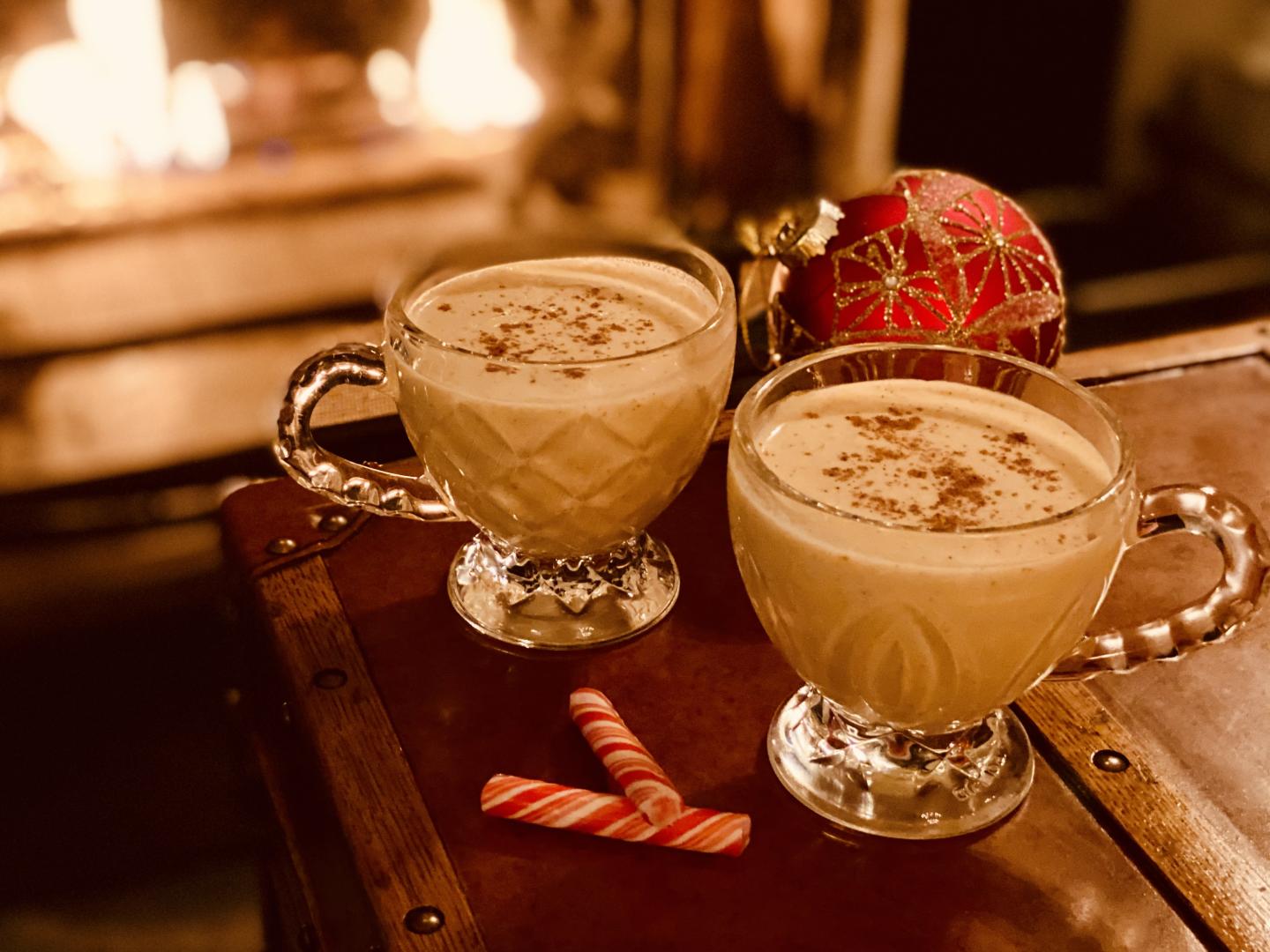 Holiday eggnog and decorations by the fire