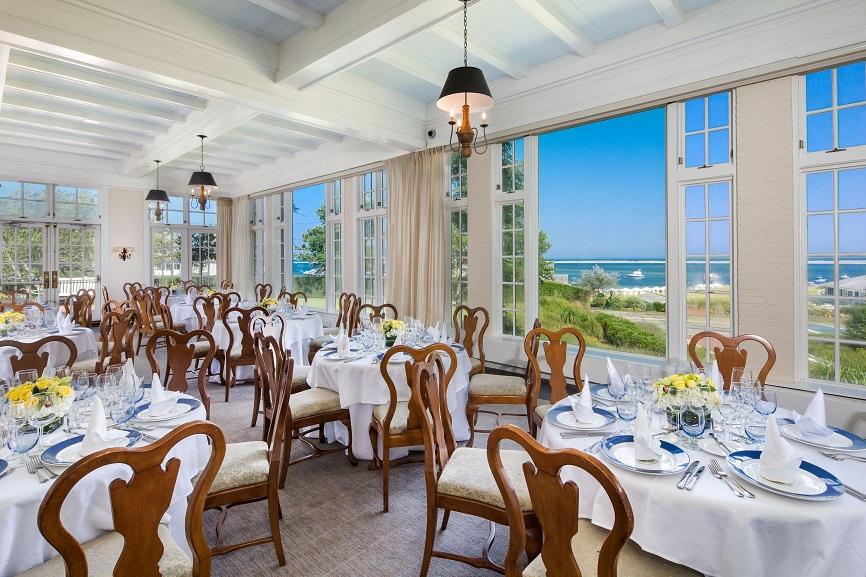 Harbor View Room with circular tables and a view outdoors