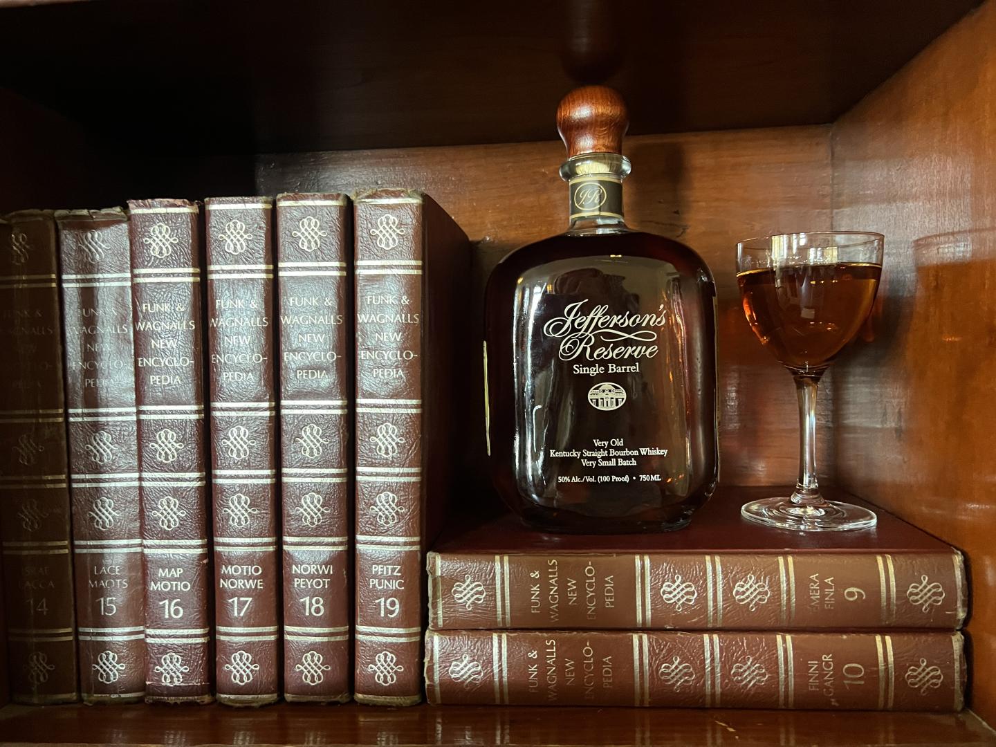 Jeffersons Reserve with glass on bookshelf