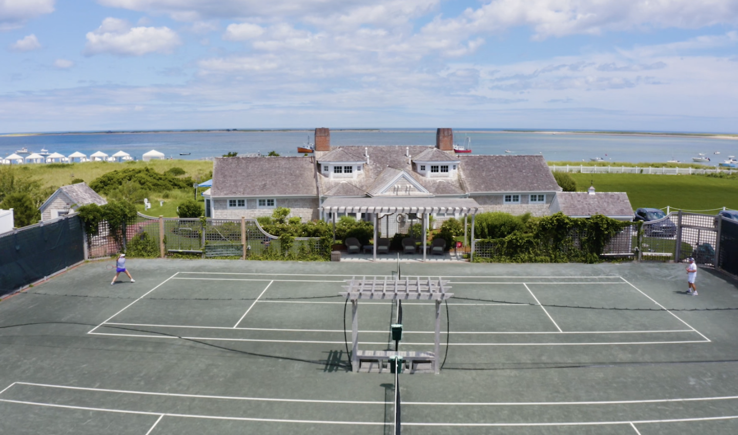 Tennis court aerial with water in background