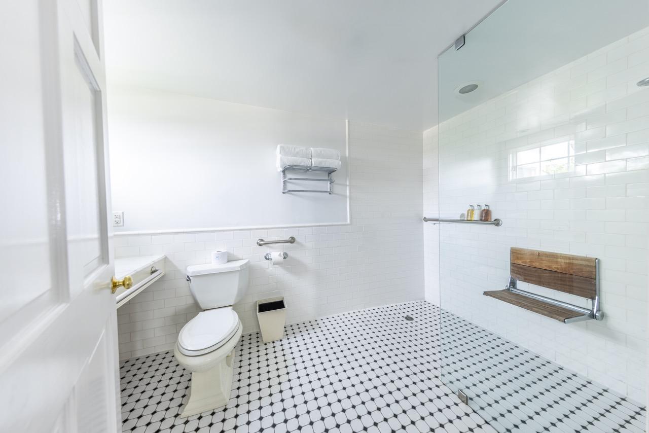 Accessible guest bathroom with roll in shower