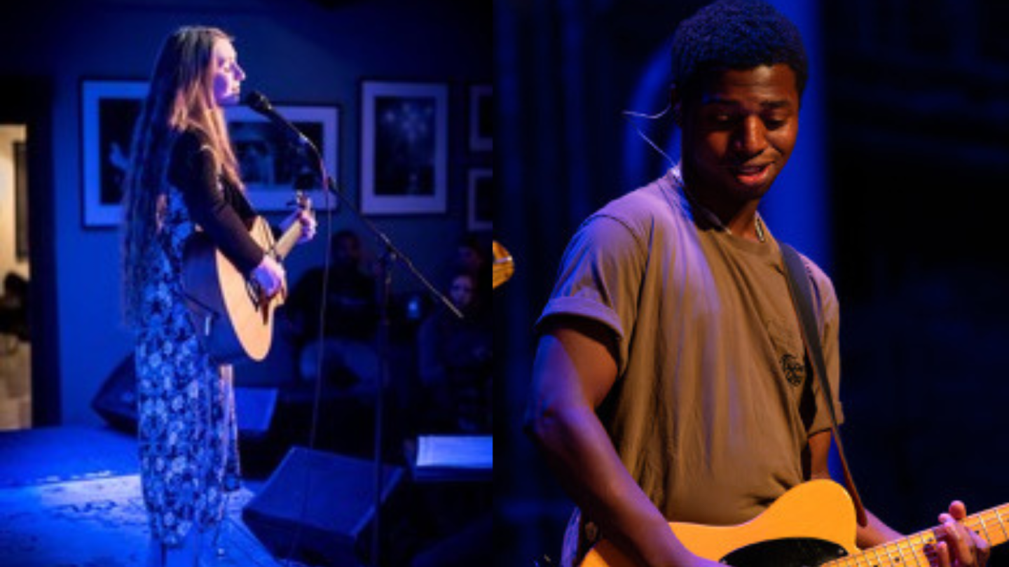 Singers performing on stage, blue lighting, man with guitar, woman with microphone.