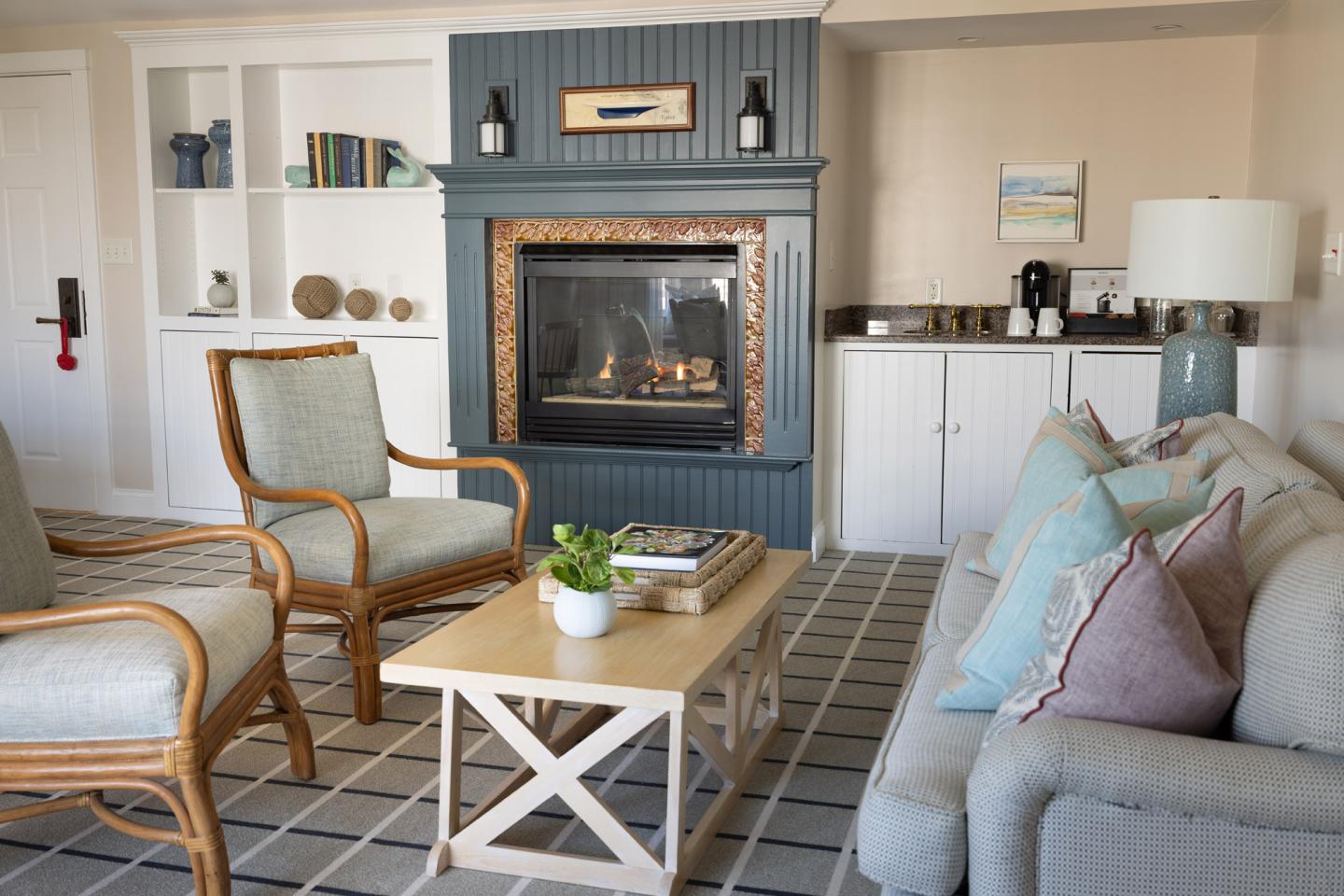 Cozy living room with a fireplace, sofa, armchairs, and a coffee table.