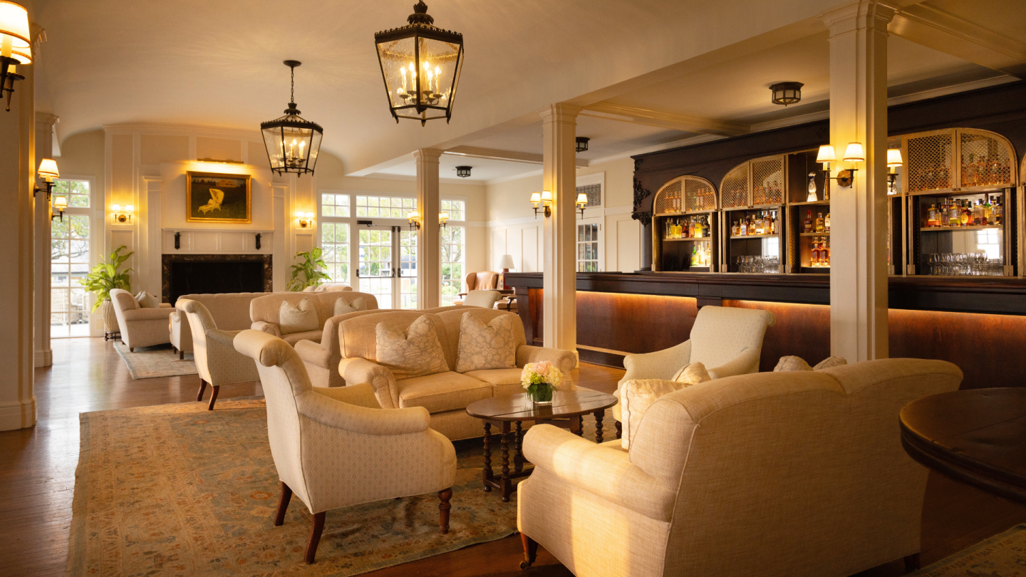 Cozy lounge with beige sofas, warm lighting, and elegant decor.