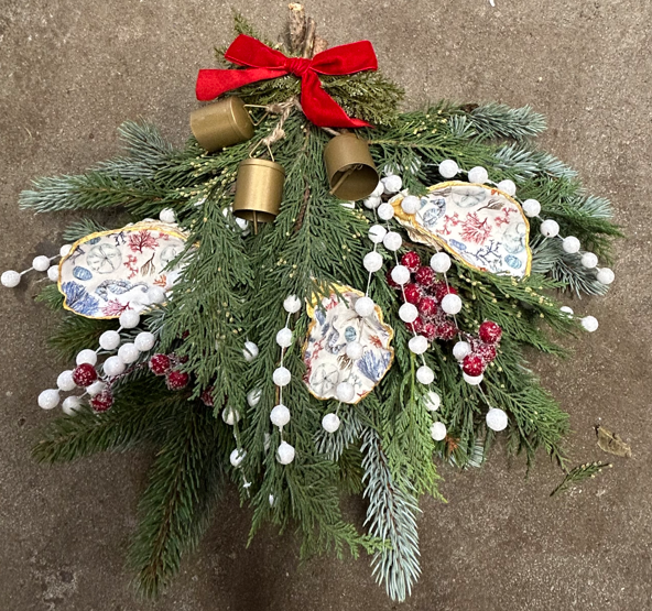 Festive greenery with red bow, gold bells, and decorative white berries.