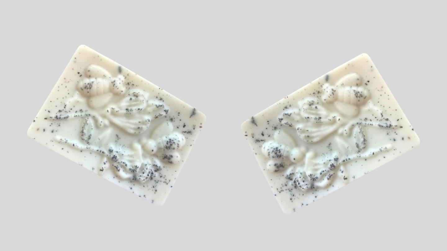 White soap bars with embossed cherubs, sprinkled with silver glitter.